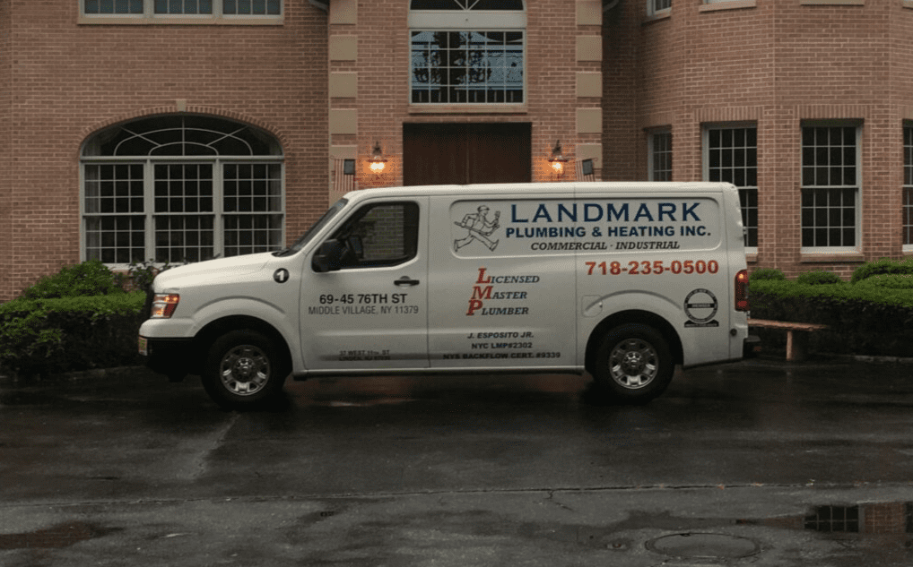 A white van parked in front of a building.